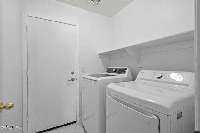 washroom featuring washer and dryer