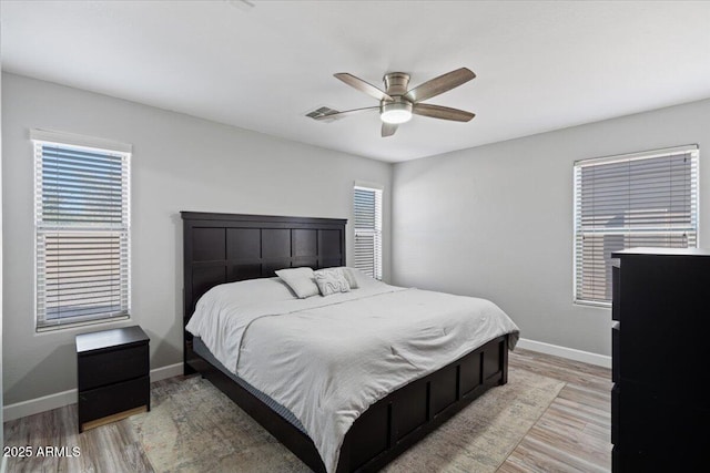 bedroom with ceiling fan and light hardwood / wood-style flooring