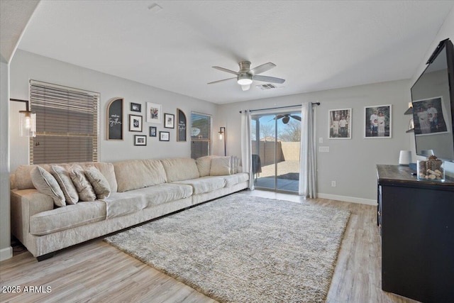 living room with ceiling fan and light hardwood / wood-style floors