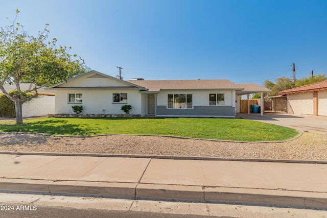 ranch-style home with a front lawn and a carport