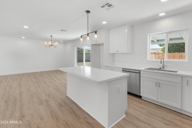 kitchen featuring hanging light fixtures, white cabinetry, a kitchen island, dishwasher, and light hardwood / wood-style flooring