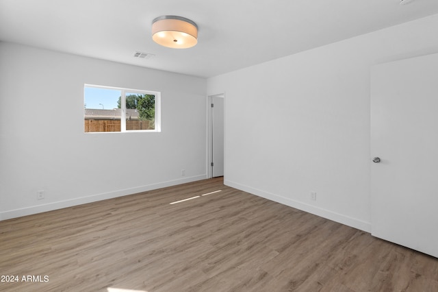 unfurnished room featuring light hardwood / wood-style floors