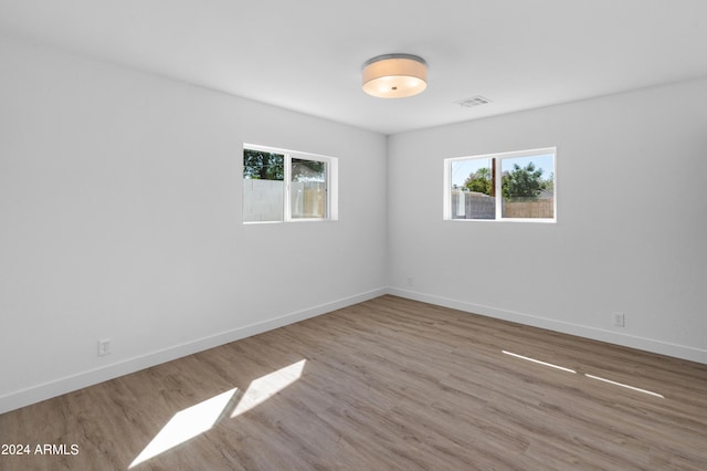 spare room featuring light hardwood / wood-style floors