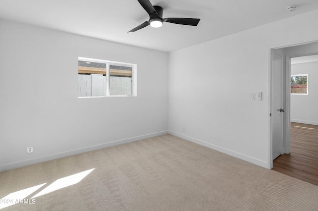 carpeted empty room featuring ceiling fan