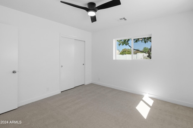 carpeted empty room with ceiling fan