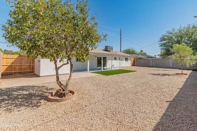 rear view of property with a patio and central AC unit