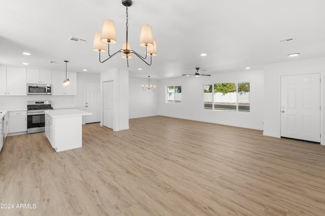 kitchen featuring ceiling fan with notable chandelier, white cabinetry, light hardwood / wood-style flooring, appliances with stainless steel finishes, and decorative light fixtures