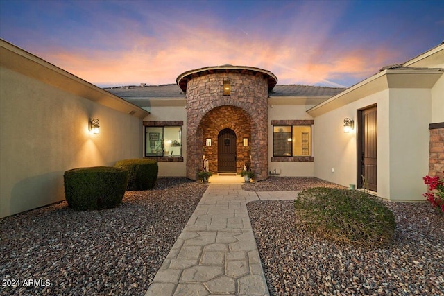 view of exterior entry at dusk