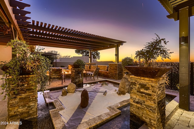 patio terrace at dusk with a pergola