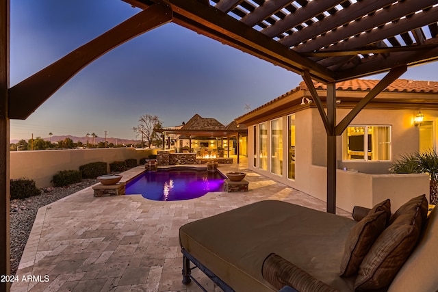 pool at dusk featuring a patio area and a pergola