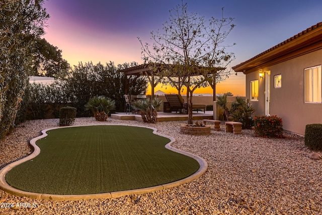 yard at dusk featuring a patio