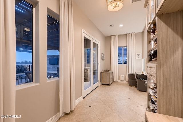 interior space featuring light tile patterned floors and french doors