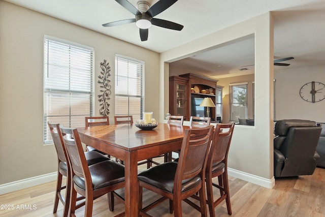 dining area with ceiling fan and light hardwood / wood-style floors