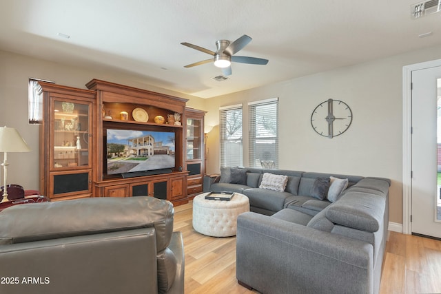 living room featuring ceiling fan and light wood-type flooring