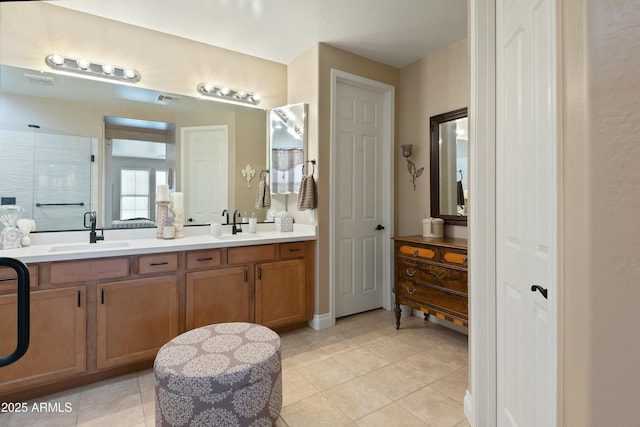 bathroom with tile patterned flooring, vanity, and an enclosed shower