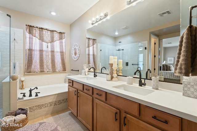 bathroom with tile patterned floors, vanity, and shower with separate bathtub