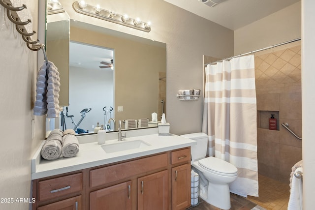 bathroom with a shower with curtain, vanity, ceiling fan, and toilet