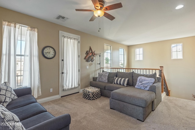 carpeted living room featuring ceiling fan