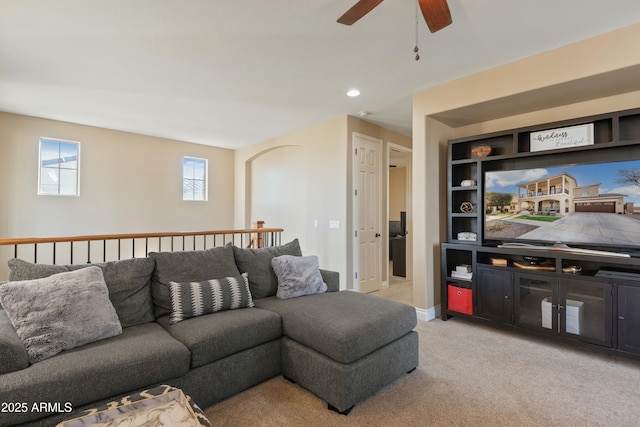 living room with light carpet and ceiling fan