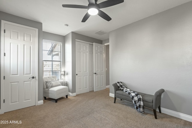 sitting room featuring ceiling fan and light carpet