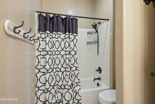 bathroom featuring shower / bath combo and toilet