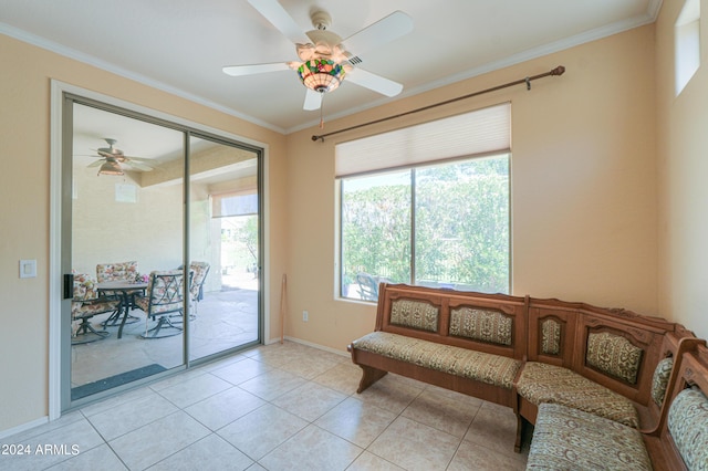 sitting room featuring light tile patterned floors, a ceiling fan, baseboards, and ornamental molding