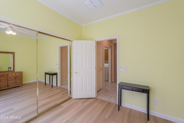 unfurnished bedroom featuring visible vents, light wood-type flooring, baseboards, and ornamental molding