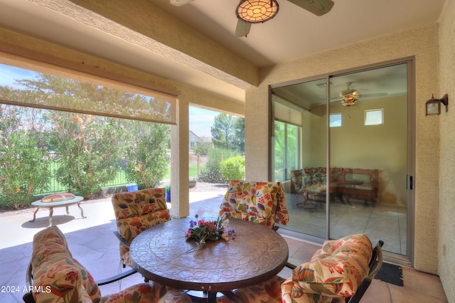 sunroom featuring ceiling fan