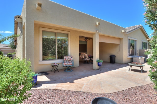 back of property featuring a patio area and stucco siding