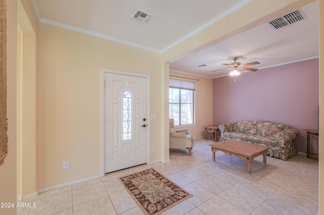 tiled foyer entrance with baseboards, visible vents, and ornamental molding