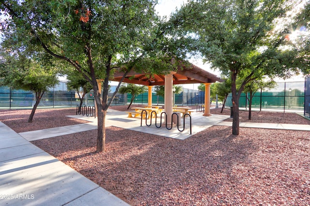 view of property's community with fence and a gazebo