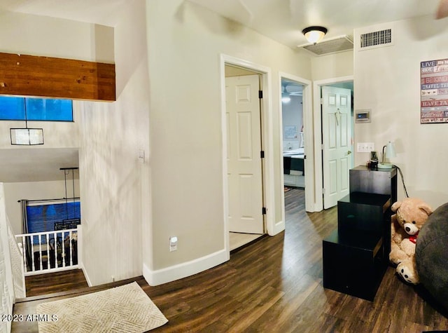 interior space with wood finished floors, visible vents, and baseboards