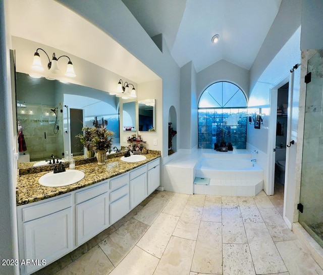 bathroom featuring a sink, lofted ceiling, a garden tub, and a stall shower