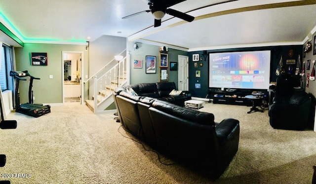 cinema room featuring ceiling fan, baseboards, ornamental molding, and carpet flooring