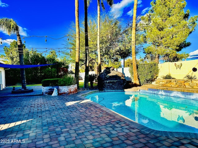 view of swimming pool with a fenced in pool, a fenced backyard, and a patio area