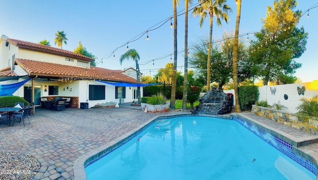 view of pool featuring ceiling fan, a fenced in pool, a fenced backyard, and a patio area