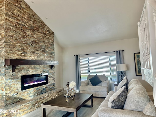 living room with a glass covered fireplace, high vaulted ceiling, and wood finished floors