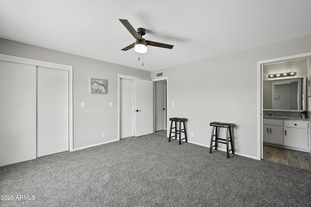 5148 E Edgewood Cir, Mesa, AZ 85206 - carpeted bedroom with multiple closets, connected bathroom, and a ceiling fan