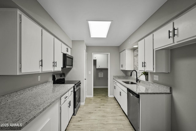 5148 E Edgewood Cir, Mesa, AZ 85206 - kitchen featuring appliances with stainless steel finishes, white cabinetry, light wood-style flooring, and light stone countertops