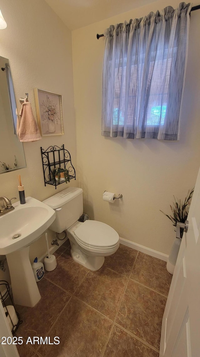 bathroom featuring toilet and tile patterned flooring