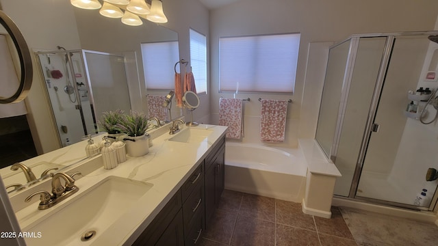 bathroom with an inviting chandelier, tile patterned floors, separate shower and tub, and vanity