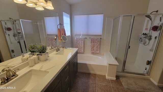 bathroom featuring an inviting chandelier, vanity, plus walk in shower, and tile patterned flooring