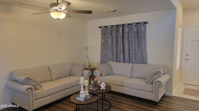 living room with dark hardwood / wood-style flooring and ceiling fan