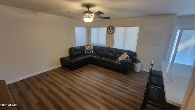 living room with dark hardwood / wood-style floors and ceiling fan