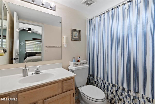 bathroom with ceiling fan, lofted ceiling, vanity, and toilet