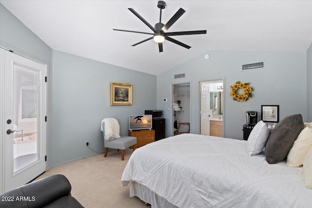 bedroom featuring ceiling fan, a closet, light carpet, ensuite bath, and vaulted ceiling