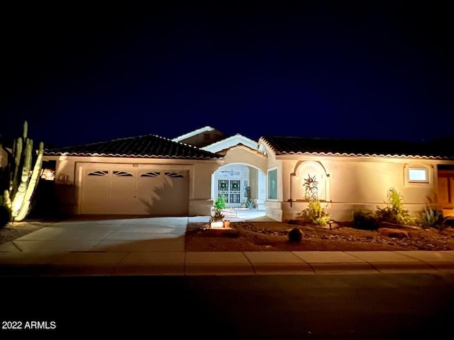 mediterranean / spanish-style home with a garage