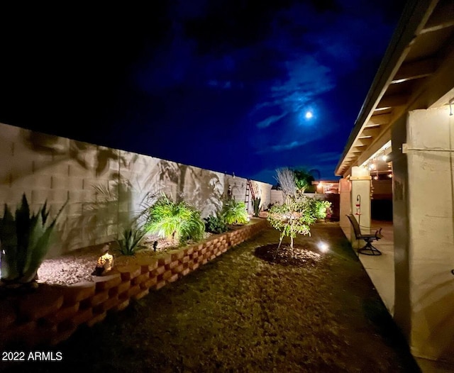 yard at twilight with a patio