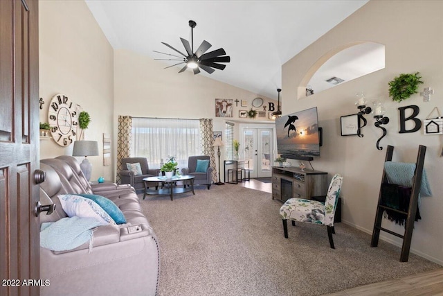 carpeted living room featuring high vaulted ceiling, ceiling fan, and french doors