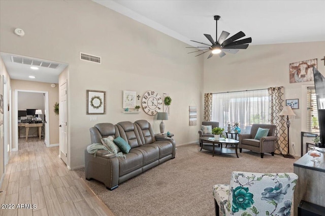 living room featuring ceiling fan, light hardwood / wood-style flooring, and lofted ceiling